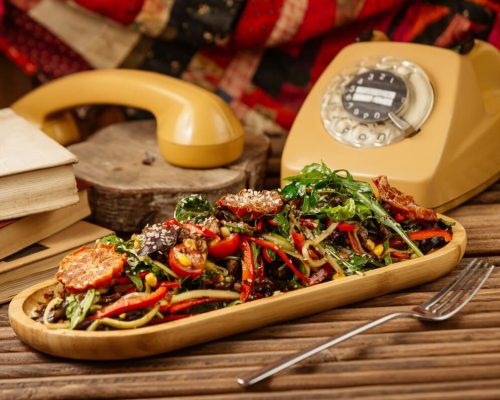 mixed-grilled-vegetable-salad-with-herbs-olive-oil-wooden-plate-with-vintage-telephone-around_114579-1529