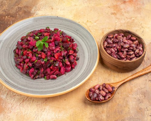 side-view-delicious-salad-with-beetroot-bean-beans-inside-outside-pot-mixed-color-table_140725-140911